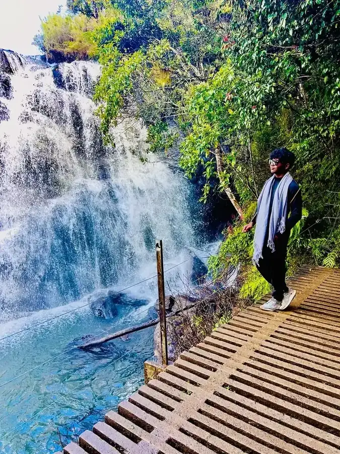Traveler at waterfall